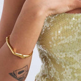 The organic shaped Arc cuff in gold 