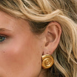 Model wearing shell shape 14k gold fill earrings 