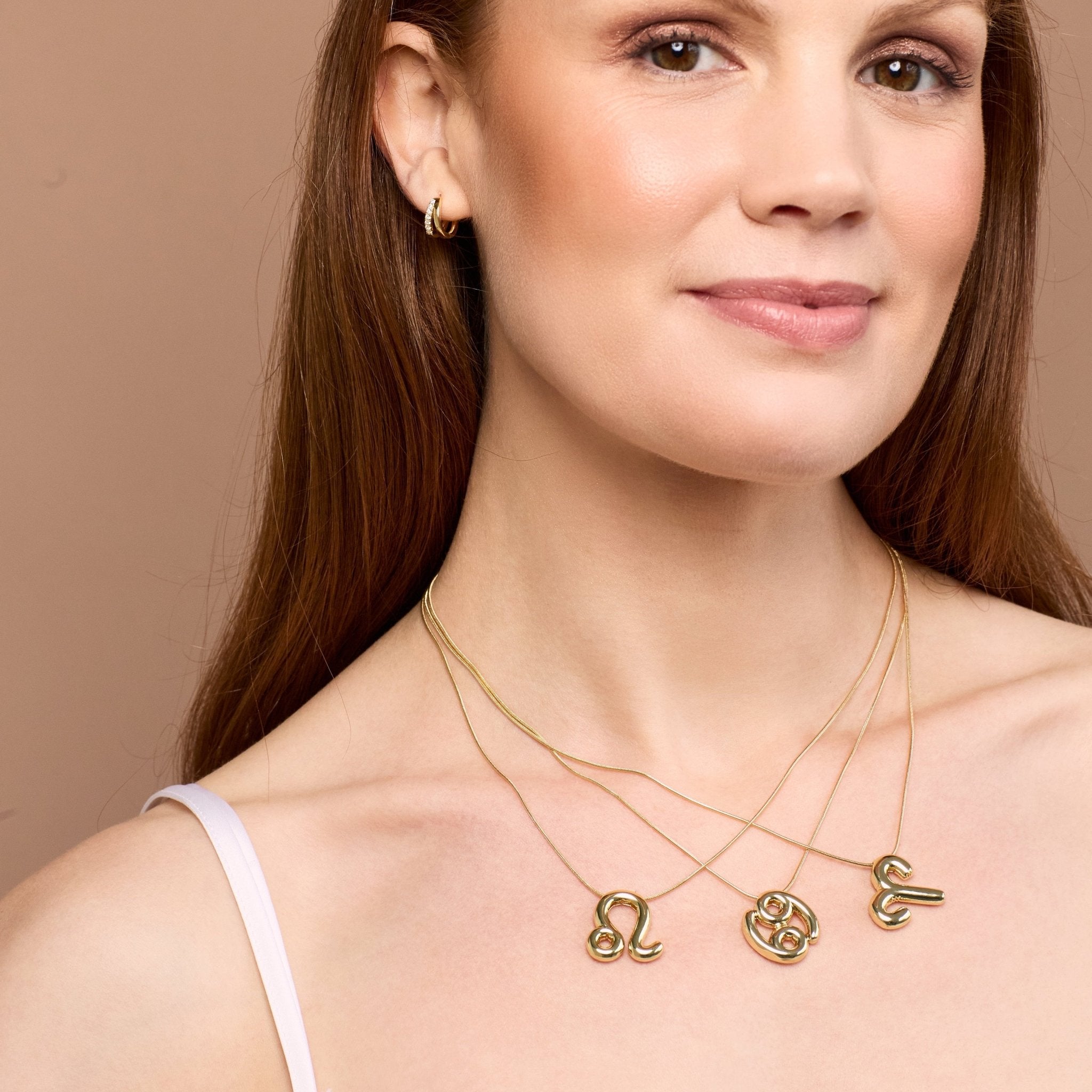 Balloon shaped star sign pendants in gold