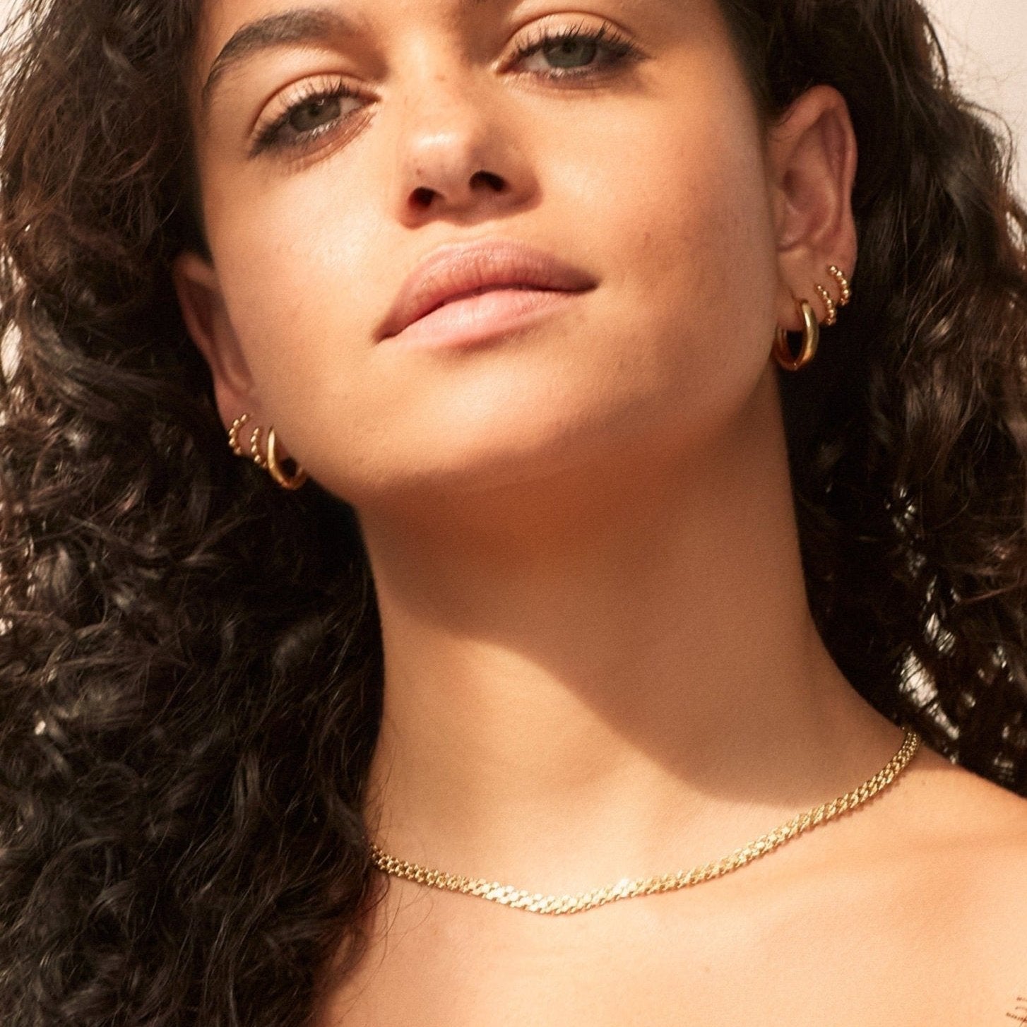 model in our 18k gold waterproof and tarnish resistant hoops