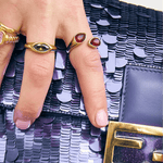 Bixby rings on a hand holding a purple bag