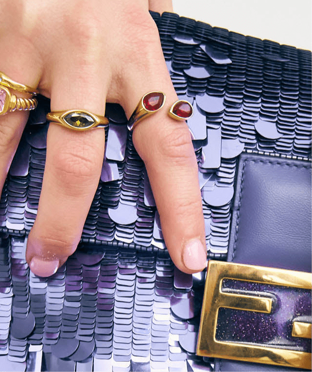 Bixby rings on a hand holding a purple bag