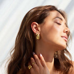 Model wearing Bixby and Co teardrop pearl and diamanté earrings