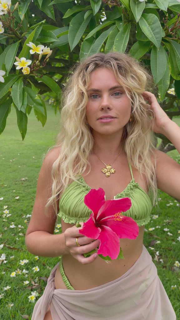 Video of model in Hibiscus flower, tropical, resort wear flower pendant and earrings